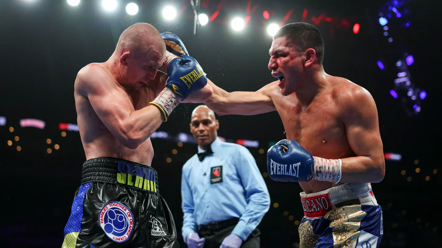 Ortiz survives two knockdowns, defeats B...